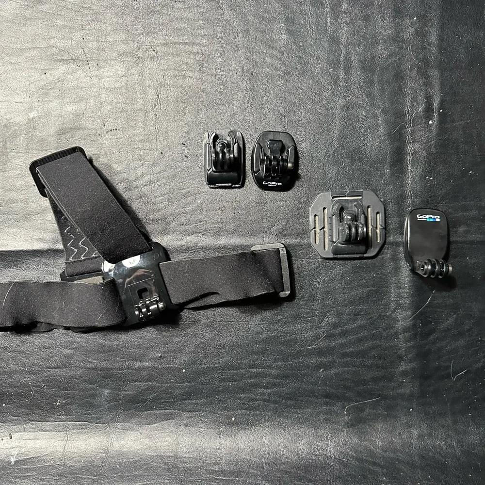 Bundle of Go Pro Head Mount, 3 Stick Mounts , Clip, Charger and Thumbscrews